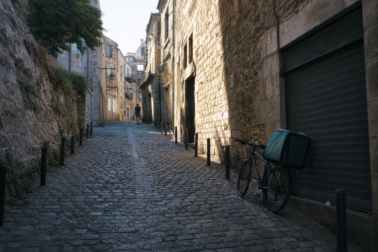 Cobblestone street of Saint-Emilion village with stone buildings, no text, no logos, no people.